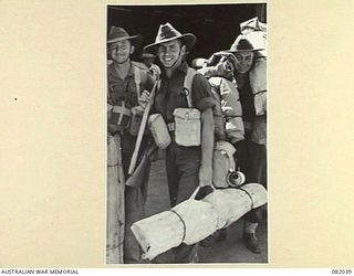 CAIRNS, QLD. 1944-10-30. TROOPS OF HEADQUARTERS COMPANY, 2/4 INFANTRY BATTALION, MOVING ALONG THE WHARF DURING EMBARKATION FOR NEW GUINEA ABOARD THE TROOPSHIP USS MEXICO. IDENTIFIED PERSONNEL ARE:- ..