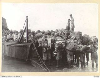 KAHILI, BOUGAINVILLE. 1945-09-30. JAPANESE TROOPS CROWDING ONTO A LANDING BARGE OF 42 LANDING CRAFT COMPANY. THE SURRENDER COMMISSION FROM HEADQUARTERS 2 CORPS IS SUPERVISING THE TRANSPORT OF ..