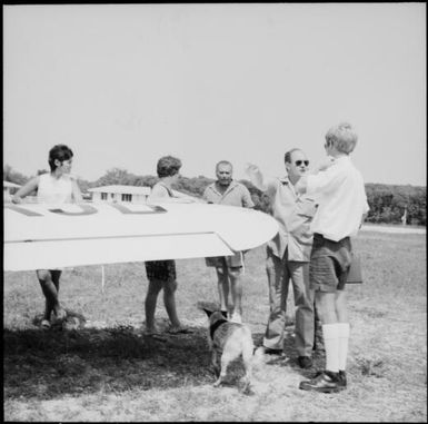 Group of people standing next to the wing of an Aeronca aeroplane, New Hebrides, 1969 / Michael Terry