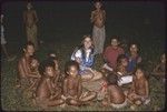 Social interaction: women, including Dona Hutchins, and children visiting at night