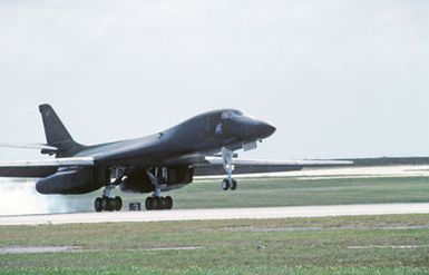 A right front view of a B-1B aircraft touching down on the runway during Exercise DISTANT MARINER