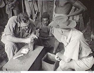 BULLDOG CAMP, NEW GUINEA. 1942-07. VIC HELTON AND DICK PAUL, OLD "NEW GUINEA" HANDS, CARRY OUT A TYPICAL CARRIERS SICK PARADE. (FILM STILL)