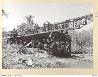 SOUTH BOUGAINVILLE, 1945-05-27. THE SAVIGE BRIDGE OVER THE JABA NO. 1 RIVER ALMOST COMPLETED. CONSTRUCTED BY MEMBERS OF 11 FIELD COMPANY ROYAL AUSTRALIAN ENGINEERS, IT WAS COMPLETED IN FIVE WEEKS ..