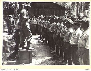 BONIS PENINSULA, BOUGAINVILLE, 1945-09-20. JAPANESE NAVAL TROOPS ON PARADE AT JAPANESE NAVAL HQ, BONIS PENINSULA. MAJOR H.ST.C. BROCKWAY, A MEMBER OF THE AUSTRALIAN SURRENDER PARTY FROM HQ 2 CORPS, ..
