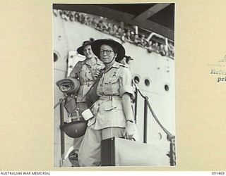 LAE, NEW GUINEA, 1945-05-07. PRIVATE E.F. DODD (1), AND SERGEANT A.E.G. LAWSON (2), COMING DOWN THE GANGWAY WHILE DISEMBARKING FROM THE MV DUNTROON. THE DUNTROON CARRIED A GROUP OF 342 AUSTRALIAN ..