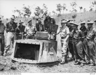 GUSIKA, NEW GUINEA. 1944-03-15. SENIOR OFFICERS INSPECTING AN ALL ROUND VISION CUPOLA FITTED TO THE DISMANTLED TURRET OF A MATILDA TANK DURING A VULNERABILITY TEST SHOOT CONDUCTED BY MEMBERS OF THE ..
