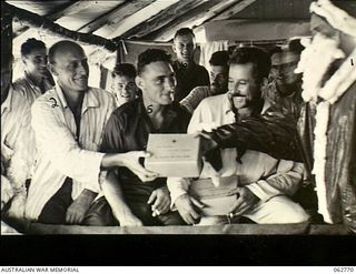 Ramu Valley, New Guinea. 1943-12-25. NX103434 Captain F. D. Smith (1) dressed as Father Christmas, distributed presents to patients of the 2/6th Australian Field Ambulance. Identified personnel ..