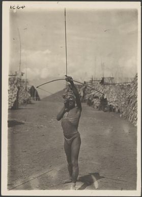 One of the little hillmen of Evisi, with bow & arrow, Papua New Guinea, ca. 1922 / Frank Hurley