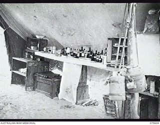 ORO BAY,NEW GUINEA. 1943-04. INTERIOR OF ONE OF THE WARD ANNEXES AT THE MEDICAL DRESSING STATION, 10TH FIELD AMBULANCE. NOTE THE MAKESHIFT SHELVING AND STORAGE FOR MEDICAL EQUIPMENT