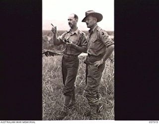 KAIAPIT, NEW GUINEA. 1943-09-23. NX55592 MAJOR E. S. OWENS, BRIGADE MAJOR (LEFT) AND NX29455 CAPTAIN F. C. NORRIE, BRIGADE AIR SUPPORT CONTROL OFFICER, BOTH OF HEADQUARTERS, 21ST AUSTRALIAN ..