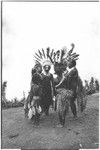 Pig festival, singsing preparations: decorated women and girls on dance ground