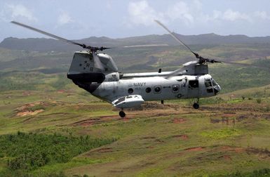 A US Navy (USN) CH-46 Sea Knight helicopter assigned to Helicopter Combat Support Squadron Five (HC-5), makes it's final flight over the country side near Andersen Air Force Base (AFB), Guam. HC-5 is replacing its inventory of Sea Knight helicopters with Black Hawk helicopters
