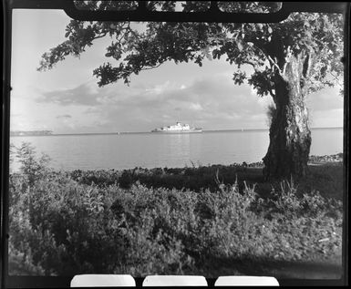 Apia waterfront, Upolu, Samoa, showing the ship Tofua in background and small boats at the beach