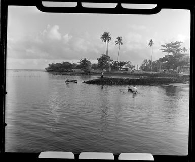 Apia waterfront, Upolu, Samoa, showing men in boats