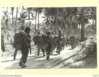 SIAR, NEW GUINEA. 1944-07-25. TROOPS OF THE 25TH INFANTRY BATTALION, MARCHING UP THE ROAD FROM THE BEACH TO THE LINES OF THE 57/60TH INFANTRY BATTALION