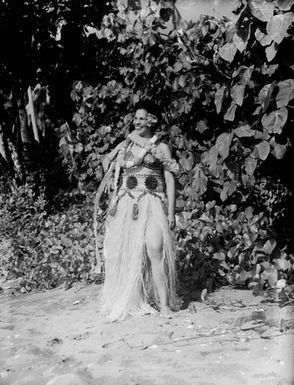 [Portrait of a woman standing on the beach shoreline]