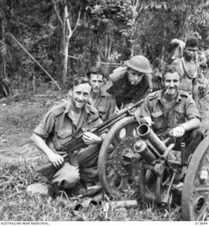 1942-11-23. NEW GUINEA. KOKODA TRACK. A CAPTURED JAPANESE MOUNTAIN GUN WHICH WAS TAKEN AT BAYONET POINT. ANOTHER GUN WAS DISMANTLED, WRAPPED IN BLANKETS AND BURIED BY THE JAPS. I HAS NOW BEEN DUG ..