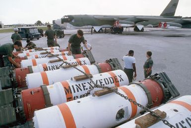 Members of the 43rd Munitions Maintenance Squadron prepare to load Mark 52 training mines onto a 43rd Strategic Wing B-52G Stratofortress aircraft during Exercise TEAM SPIRIT '85