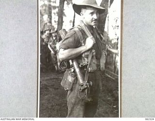 SHAGGY RIDGE, NEW GUINEA. 1943-12-27. QX51647 PRIVATE J. Q. K. THOMSETT A TRENCH MORTAR GUNNER OF THE 2/16TH AUSTRALIAN INFANTRY BATTALION, 21ST AUSTRALIAN INFANTRY BRIGADE READY TO MOVE INTO THE ..