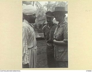 AITAPE, NEW GUINEA. 1945-03-23. LADY WAKEHURST, WEARING THE UNIFORM OF A SENIOR RED CROSS REPRESENTATIVE (3), SPEAKING WITH SERGEANT KHAZON SIGH OF THE INDIAN ARMY WHO IS A PATIENT IN THE 104 ..