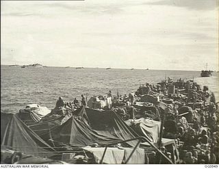 AT SEA NEAR AITAPE, NORTH EAST NEW GUINEA. 1944-04-21. UNMOLESTED BY JAPANESE ATTACK THE CONVOY WHICH WAS TO LAND RAAF PERSONNEL AT KORAKO VILLAGE MOVES TO ITS OBJECTIVE WITH DECK AND BETWEEN DECKS ..