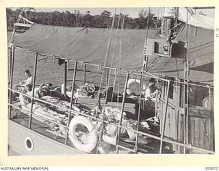 LALUM, BOUGAINVILLE, 1945-06-12. WOUNDED STRETCHER CASES TRANSFERRED FROM 19 FIELD AMBULANCE MAIN DRESSING STATION ON THE FORWARD DECK OF THE HOSPITAL SHIP STRADBROKE. THE VESSEL, IN PRE- WAR DAYS ..