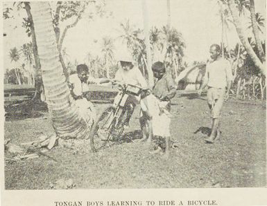 Tongan boys learning to ride a bicycle