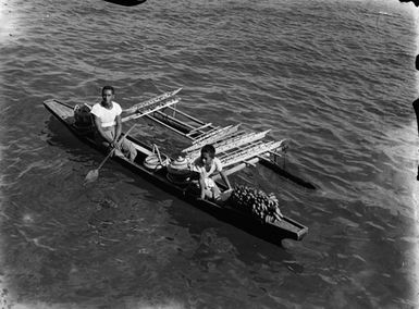 [High angle view of two people on an outrigger canoe]