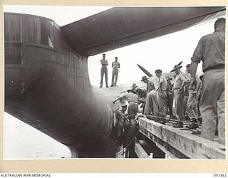 PALMALMAL PLANTATION, NEW BRITAIN, 1945-06-23. CAPT E.V. HAYWOOD, ROYAL AUSTRALIAN ARTILLERY, LEAVING AN ROYAL AUSTRALIAN ARTILLERYF MARTIN MARINER FLYING BOAT AFTER A SIX HOUR TRIP FROM CAIRNS. ..