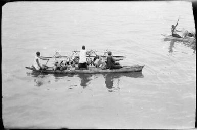 Outrigger canoe laden with produce and three women as crew, Rabaul, New Guinea, ca. 1929, 1 / Sarah Chinnery