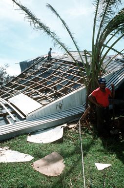 A workman stands by a demolished building in the village of Tuasivi on the island of Savaii during disaster relief efforts in the area. The building is one of many structures which sustained damage from Cyclone Ofa, which hit Savaii and the island of Upolu