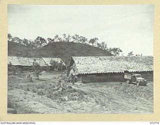 PORT MORESBY, NEW GUINEA. 1944-05-01. THE Q AND RATION STORE, HEADQUARTERS NEW GUINEA FORCE, WITH THE CAMP STAFF OFFICE AT THE BACKGROUND