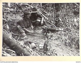 WEWAK AREA, NEW GUINEA. 1945-06-28. TROOPS OF 2/8 INFANTRY BATTALION TEST FIRING A CAPTURED JAPANESE TYPE 92 MACHINE GUN. IDENTIFIED PERSONNEL ARE:- PRIVATE R.L. SHEARER (1); LIEUTENANT J.M. ..