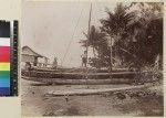 Men seated on shore with canoe, Wari Island, Papua New Guinea, ca. 1890