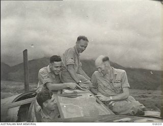 MILNE BAY, PAPUA. C. 1943-11-15. "TOO CLOSE FOR COMFORT" SAYS FLIGHT SERGEANT (FLT SGT) RON CAFFIN OF ORMOND, VIC (RIGHT), PILOT OF A BEAUFORT BOMBER AIRCRAFT OF NO. 100 SQUADRON RAAF, POINTING TO ..