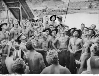 LAE, NEW GUINEA. 1944-11-02. A POSED PHOTOGRAPH DEPICTING A "TWO-UP" GAME ABOARD THE TROOPSHIP, "CAPE ALEXANDER". NO IDENTIFICATION DETAILS FOR MEN IN THIS GROUP