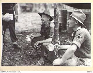 WEWAK AREA, NEW GUINEA, 1945-06-29. MAJ-GEN J.E.S. STEVENS GOC 6 DIVISION (1) WITH LT-COL J.A. BISHOP (2) DURING HIS VISIT OF INSPECTION TO MOUNT SHIBURANGU AFTER ITS CAPTURE BY C COMPANY, 2/8 ..