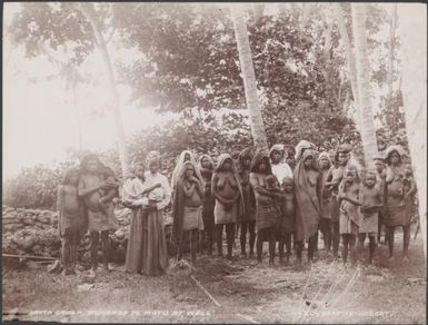 Women and children standing at a well in Te Motu, Santa Cruz Islands, 1906 / J.W. Beattie