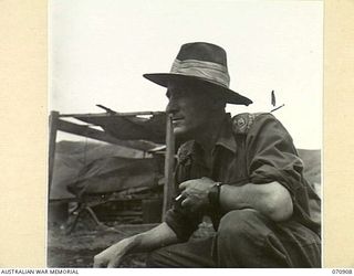 WAU - LAE ROAD, NEW GUINEA, 1944-02-26. NX149478 LIEUTENANT A.A. ROWAN (1) THE SECOND IN CHARGE OF THE 1ST MECHANICAL EQUIPMENT PLATOON, 2/1ST RAILWAY CONSTRUCTION COMPANY, (MECHANICAL EQUIPMENT), ..