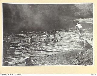 PORT MORESBY, PAPUA. 1942-07. RELAXING AFTER A LONG ROUTE MARCH, AUSTRALIAN TROOPS ENJOY THE FRESHNESS OF A NEW GUINEA MOUNTAIN STREAM