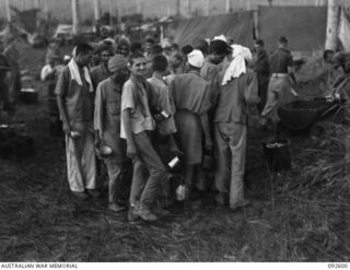 WEWAK AREA, NEW GUINEA, 1945-05-23. INDIANS WHO HAVE ESCAPED FROM THE JAPANESE LINE UP FOR A MEAL AT HQ COMPANY COOKHOUSE, 2/8 INFANTRY BATTALION