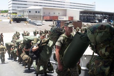 Numerous US Marine Corps (USMC), US Navy (USN) and Australian (AUS) Army units, board the USN Amphibious Assault Ship USS TARAWA (LHA 1) at pier K-10, Pearl Harbor, Hawaii (HI), in support of an amphibious exercise, Rim Of The Pacific (RIMPAC) 2004