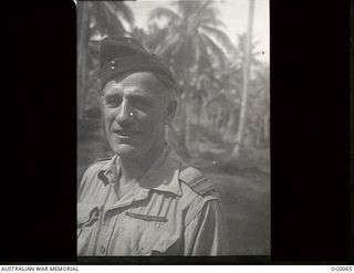 PORT MORESBY, PAPUA. C. 1943. PORTRAIT OF RAAF CHAPLAIN PADRE DEBENHAM WHO CONDUCTED HIS LITTLE CHURCH AMONG THE COCONUT PALMS