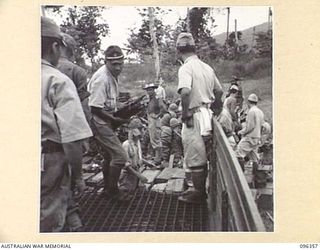 KAIRIRU ISLAND, NEW GUINEA, 1945-09-08. JAPANESE SOLDIERS LOADING RIFLES FROM THEIR WEAPON DUMP INTO TRUCKS FOR TRANSPORTATION TO HQ 6 DIVISION. STAFF OFFICERS OF HQ 6 DIVISION VISITED THE ISLAND ..
