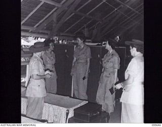 LAE, NEW GUINEA, 1946-01-19. INSPECTION OF THE LIVING QUARTERS AT AWAS BARRACKS DURING THE VISIT OF COLONEL (COL) S. H. IRVING, CONTROLLER, AWAS AND LIEUTENANT-COLONEL (LT-COL) I. V. MURPHY, DEPUTY ..