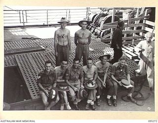 THE WHARF, JACQUINOT BAY, NEW BRITAIN, 1945-08-13. THE LOADING PARTY RESTS AFTER COMPLETING PREPARATIONS ON THE TROOPSHIP VAN OUTHOORN FOR THE RETURN OF HEADQUARTERS 5 DIVISION TROOPS TO AUSTRALIA