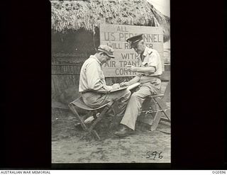 VIVIGANI, GOODENOUGH ISLAND, PAPUA. C. 1944. THE ENDS OF A FOLDING CAMP STRETCHER WERE USED TO MAKE THE SEAT FOR FIRST LIEUTENANT JIM BOWLES RAAF OF BELLEVUE HILL, NSW (LEFT). FLYING OFFICER JIM ..