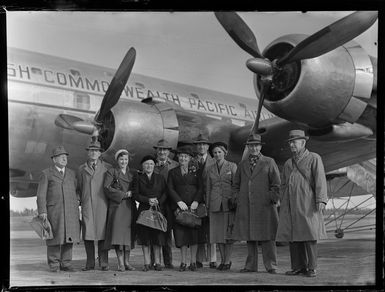 Group of people standing beside the British Commonwealth Pacific Airlines aircraft RMA Endeavour at Whenuapai