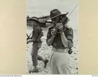 GUSIKA, NEW GUINEA, 1944-03-16. NX151704 LIEUTENANT J. SCOTT-STEVENSON ( ), SECOND IN CHARGE, SIGNALS SECTION, 4TH INFANTRY BRIGADE, OPERATING A SCR 536 (SET COMPLETE RADIO). VX35038 CORPORAL H.G. ..