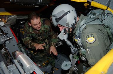 US Air Force (USAF) Major (MAJ) General (GEN) Mike DeCuir, Director of Air and Space Operations (ASO), Headquarters Air Combat Command (ACC), Langley Air Force Base (AFB), Virginia (VA), receives training from MASTER Sergeant (MSGT) David Williams on an ejection seat at Barksdale Air Force Base's new B-52H Stratofortress egress trainer in preparation for a flight to Andersen AFB, Guam (GU)